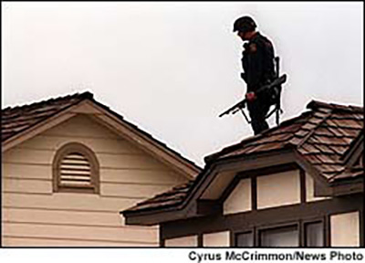 Columbine SWAT team secure the roof of nearby house