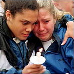 Students console each other at a candlelight vigil